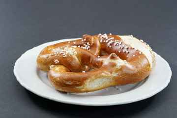 Fresh pretzel with sausage and cheese is a tasty snack