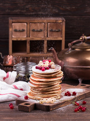 American pancakes with fresh berries on wooden background