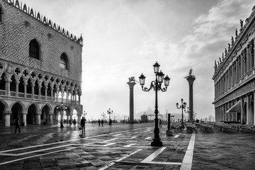 Black and white photo of San Marco square in Venice at sunrise with Doge's Palace, Palazzo Ducale...