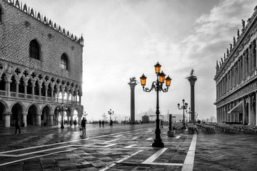 Black and white photo of San Marco square in Venice at sunrise with Doge's Palace, Palazzo Ducale...