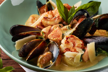 Assorted seafood with creamy sauce and parmesan