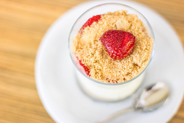 Magnolia dessert in a glass with cream and strawberries
