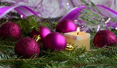 Christmas decoration with candle and balls close-up.