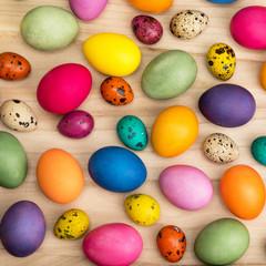  colorful easter eggs on a wooden background, top view