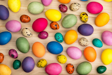 Fototapeta na wymiar colorful easter eggs on a wooden background, top view