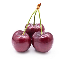 Three sweet cherries isolated on white background.