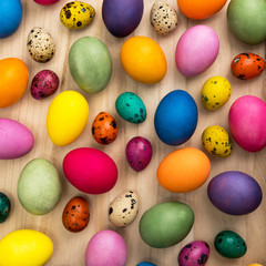  colorful easter eggs on a wooden background, top view