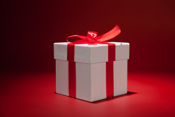 White gift box on red background. Copy spase