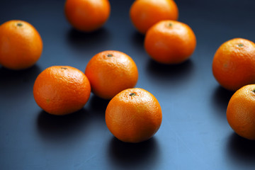 ripe tangerines on a dark background