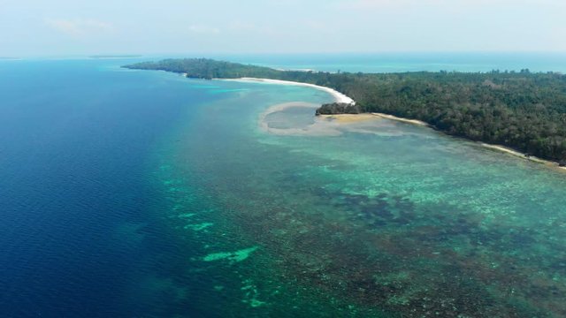 Aerial: flying over tropical beach island coral reef turquoise caribbean sea. Indonesia Moluccas archipelago, Kei Islands, Pasir Panjang, Banda Sea. Top travel destination, best diving snorkeling