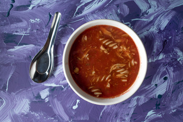 A view of a bowl of tomato soup with sour cream.