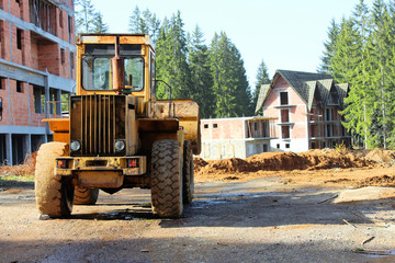 Obraz na płótnie Canvas yellow bulldozer at construction site