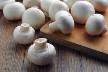 Fototapeta na wymiar white champignons on the cutting table