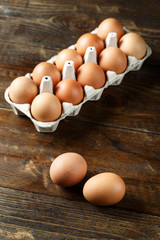 eggs in a tray on wooden background