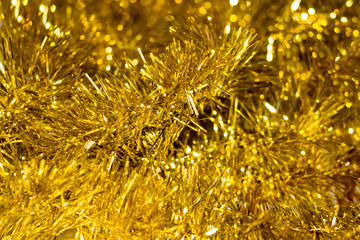 Colorful Christmas tinsel. New year's fluffy gold tinsel, and pink tinsel. Sparkling ornament decoration concept.