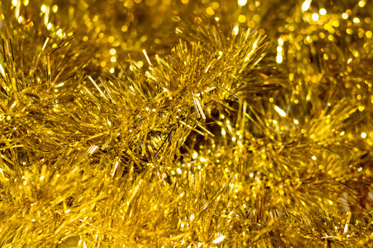 Colorful Christmas tinsel. New year's fluffy gold tinsel, and pink tinsel. Sparkling ornament decoration concept. - Powered by Adobe