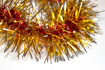 Colorful Christmas tinsel. New year's fluffy gold tinsel, tinsel, and pink tinsel. Sparkling ornament decoration concept.