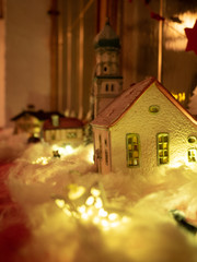 Christmas decorations, small house toy on a snowy background