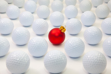 Pattern with white golf balls and red Christmas decoration
