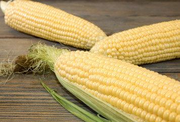 Fresh corn or cob on a rustic wooden table, close-up
