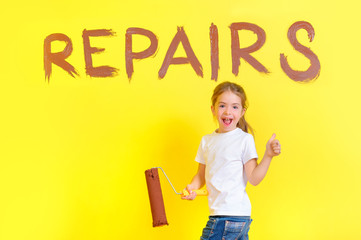 funny girl with a roller for painting in her hands is playing the fool around the painted wall with the inscription repair, shows a class