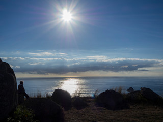 Paisaje del Cabo de Finisterre, en la puesta de sol a contraluz, verano de 2018, en Galicia,...
