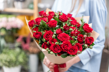 bouquet in the hands of a cute girl. garden red spray roses. Color passionately scarlet, Autumn mood - 236829625