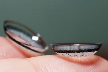 Grey contact lenses on the finger so close