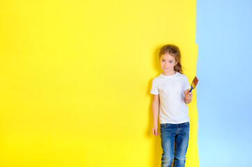 a little girl with a paint brush in her hands, stands near a painted wall, choosing tsieta for repair