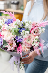 European floral shop. Bouquet of beautiful Mixed flowers in woman hand. Excellent garden flowers in the arrangement , the work of a professional florist.