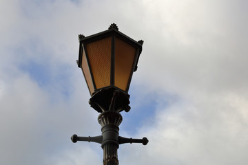 Fototapeta na wymiar Vintage iron lantern on the street of the modern city