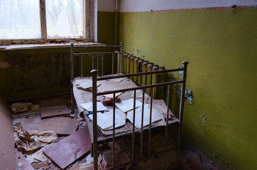 Bedroom in abandoned kindergarten in destroyed village of Kopachi, Chernobyl NPP alienation zone, Ukraine