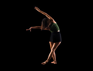 Young girl dancing in studio on isolated background