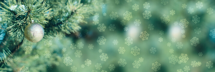 Fototapeta premium Golden Christmas ball on the fir branch. Christmas background. Snowflakes, glow, bokeh, stars