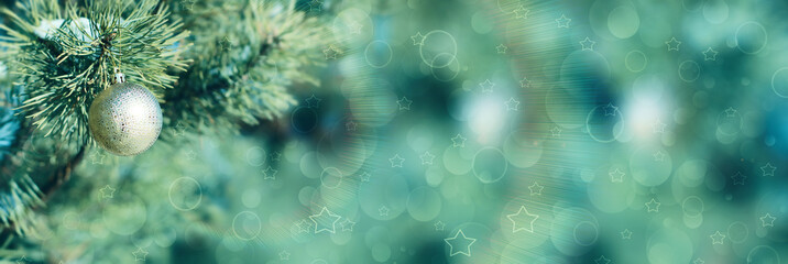 Golden Christmas ball on the fir branch. Christmas background. Snowflakes, glow, bokeh, stars