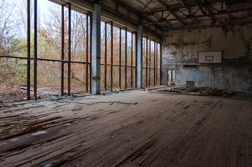 Fototapeta na wymiar Sports Hall of swimming pool Azure in dead abandoned ghost town of Pripyat in Chernobyl alienation zone, Ukraine
