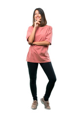 Full body of  Young girl with pink shirt smiling a lot while putting hands on chest. Ideal for use in architectural designs