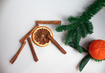 Christmas composition. Cinnamon stick, orange on white background. Flat lay, top view, copy space