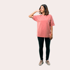 Fototapeta premium Full body of Young girl with pink shirt listening something