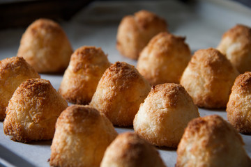 group of coconut cookies in a baking pan just cooked