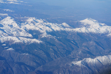 Fototapeta premium View of the Alps from the window of the plane