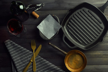 empty cookware over a dark wood table