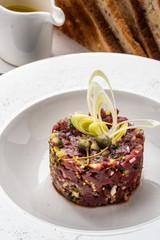 Beef tartare with leek, capers and crispy croutons.