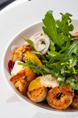 Fresh Sicilian Salad with shrimps, arugula, cheese and ripe orange slices.
