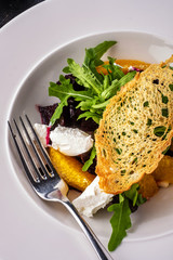 Salad with dried beetroot, apple, orange and soft goat cheese.