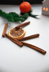Christmas composition. Cinnamon stick, orange on white background. Flat lay, top view, copy space