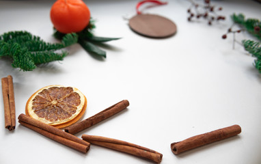 Fototapeta na wymiar Christmas composition. Cinnamon stick, orange on white background. Flat lay, top view, copy space