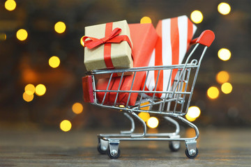 Christmas gifts shopping. Shopping cart with wrapped Christmas gifts