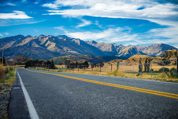 New Zealand Yellow Highway lines converging into the distance with no recognizable people or...