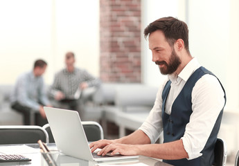 businessman working on a laptop in a modern office